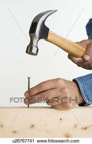 close-up-of-man-using-hammer-and-nail-stock-image__u26767741.jpg